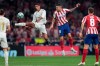 Real Madrid's Raphael Varane jumps to kick the ball before Real Madrid's Marco Asensio, center right, during the Spanish La Liga soccer match between Atletico Madrid and Real Madrid at the Wanda Metropolitano stadium in Madrid, Saturday, Sept. 28, 2019. (AP Photo/Bernat Armangue)
