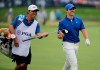 Rory McIlroy, of Northern Ireland, hands an iron to his caddie on the 15th fairway during the final round of the PGA Championship golf tournament, Sunday, May 19, 2019, at Bethpage Black in Farmingdale, N.Y. (AP Photo/Seth Wenig)