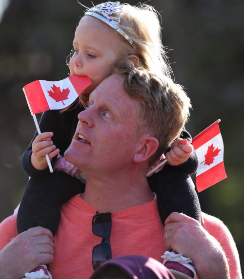 Melissa Tait / Winnipeg Free Press
A princess waits for her prince: Kiri MacAulay, 3, shows her patriotic pride on dad Scott's shoulders at the legislature.
