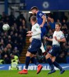 Chelsea's Olivier Giroud, center, heads the ball wide during the second leg of the English League Cup semifinal soccer match between Chelsea and Tottenham Hotspur at Stamford Bridge stadium in London, Thursday, Jan. 24, 2019. (AP Photo/Alastair Grant)