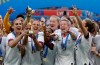 United States' team celebrates with trophy after winning the Women's World Cup final soccer match between US and The Netherlands at the Stade de Lyon in Decines, outside Lyon, France, Sunday, July 7, 2019. (AP Photo/Alessandra Tarantino)