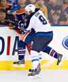 Jason Franson / The Canadian Press
Winnipeg Jets' Evander Kane (9) checks Edmonton Oilers' Jordan Eberle (14) during first-period NHL hockey action in Edmonton Tuesday.