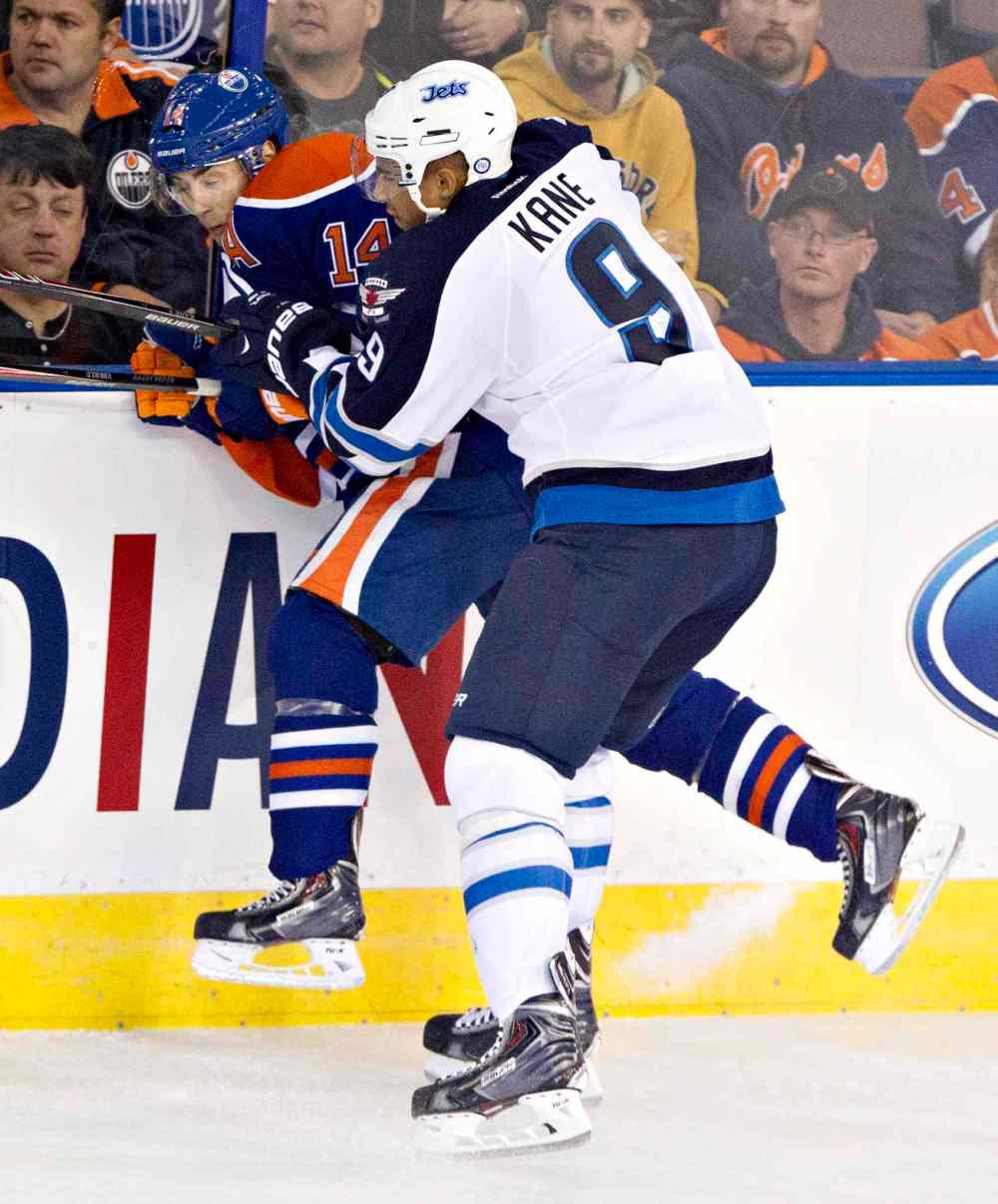 Jason Franson / The Canadian Press
Winnipeg Jets' Evander Kane (9) checks Edmonton Oilers' Jordan Eberle (14) during first-period NHL hockey action in Edmonton Tuesday.