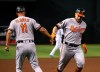 Baltimore Orioles' Renato Nunez, right, celebrates his home run against the Arizona Diamondbacks with Orioles third base coach Jose David Flores (11) during the second inning of a baseball game Tuesday, July 23, 2019, in Phoenix. (AP Photo/Ross D. Franklin)