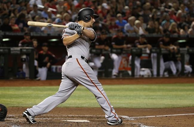 San Francisco Giants' Alex Dickerson follow through on a two-run double against the Arizona Diamondbacks during the third inning of a baseball game Saturday, June 22, 2019, in Phoenix. (AP Photo/Ross D. Franklin)