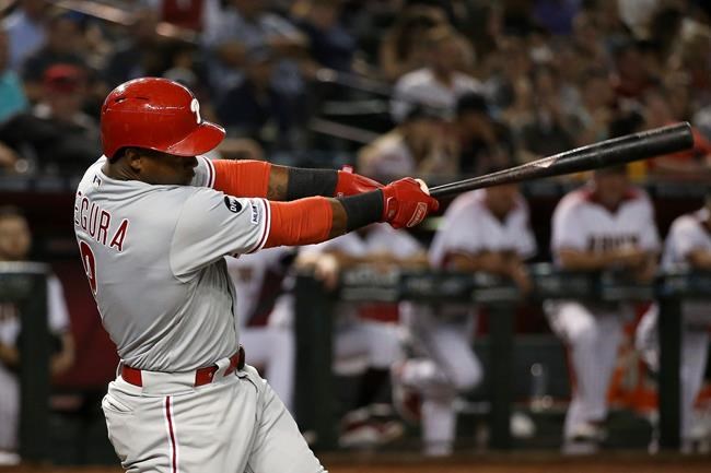 Philadelphia Phillies' Jean Segura connects for a run-scoring single against the Arizona Diamondbacks during the third inning of a baseball game Monday, Aug. 5, 2019, in Phoenix. (AP Photo/Ross D. Franklin)