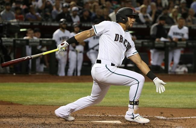 Arizona Diamondbacks' David Peralta watches his RBI triple against the Atlanta Braves during the sixth inning of a baseball game Friday, May 10, 2019, in Phoenix. (AP Photo/Ross D. Franklin)