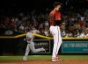 Arizona Diamondbacks starting pitcher Alex Young (49) pauses on the mound after giving up a grand slam to Milwaukee Brewers' Tyler Saladino, left, during the fourth inning of a baseball game Sunday, July 21, 2019, in Phoenix. (AP Photo/Ross D. Franklin)