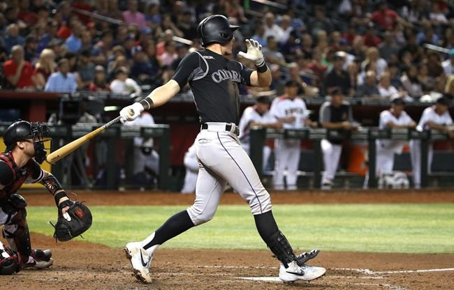 Colorado Rockies' Ryan McMahon watches his two-run double against the Arizona Diamondbacks during the seventh inning of a baseball game Wednesday, June 19, 2019, in Phoenix. (AP Photo/Ross D. Franklin)