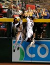Arizona Diamondbacks center fielder Jarrod Dyson, left, makes a catch taking a home run away from Los Angeles Dodgers' Joc Pederson as Dyson collides with Diamondbacks right fielder Tim Locastro (16) during the seventh inning of a baseball game Wednesday, June 26, 2019, in Phoenix. (AP Photo/Ross D. Franklin)