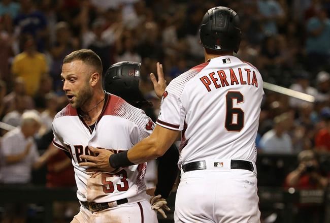 Arizona Diamondbacks' Christian Walker (53) and David Peralta (6) celebrate their runs scored against the Los Angeles Dodgers during the eighth inning of a baseball game, Monday, June 24, 2019, in Phoenix. (AP Photo/Ross D. Franklin)