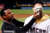 Arizona Diamondbacks' Josh Rojas, right, gets a pie in the face from Adam Jones, left, during an on-field interview after the team's baseball game against the Los Angeles Dodgers on Friday, Aug. 30, 2019, in Phoenix. Rojas had a two-run home run in the seventh as the Diamondbacks won 5-4. (AP Photo/Ross D. Franklin)