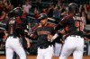 Arizona Diamondbacks' Eduardo Escobar, middle, celebrates with Jarrod Dyson (1) and Abraham Almonte (48) after all score runs against the Miami Marlins on a three-run double hit by Diamondbacks' Jake Lamb during the seventh inning of a baseball game, Monday, Sept. 16, 2019, in Phoenix. (AP Photo/Ross D. Franklin)