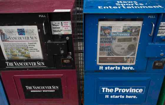 JONATHAN HAYWARD / THE CANADIAN PRESSNewspaper boxes containing the Vancouver Sun and the Province are seen in downtown Vancouver, Tuesday. Postmedia announced that they will combine the two newspapers' newsrooms but to continue to operate as separate brands along with further announcements of more layoffs for the company nation wide.