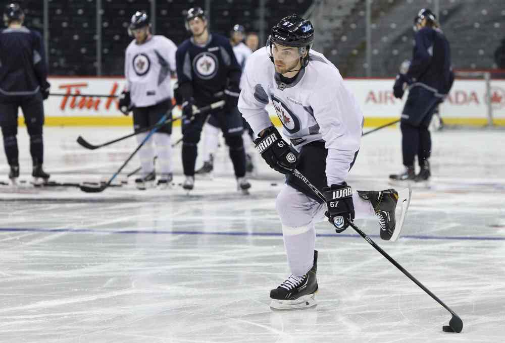 Mike Deal / Winnipeg Free Press
Winnipeg Jets' Michael Frolik (67) takes a shot during a very short practice Sunday.