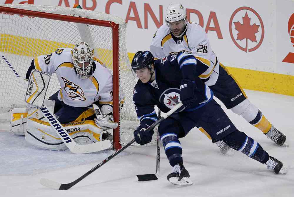 John Woods / Winnipeg Free Press
Winnipeg Jets' Mark Scheifele (55) goes for the wrap-around against Nashville Predators' goaltender Carter Hutton (30) and Paul Gaustad (28) during the third period of Tuesday's game. The Predators won 4-3.