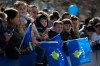 Kosovars wave national flags as they wait to watch a military parade, during celebrations to mark the 11th anniversary of independence in Pristina, Sunday, Feb. 17, 2019. Thousands of civilians filled downtown Pristina Sunday decorated with national and U.S. flags while infantry troops with light weaponry of the Kosovo Security Forces, now transformed into a regular army, paraded as a ‚Äúprofessional, multiethnic army serving the youngest country in the world,‚Äù as President Hashim Thaci said. (AP Photo/Visar Kryeziu)