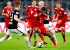 File-Picture taken on Dec.19, 2018 shows Bayern's Kingsley Coman, foreground, and Leipzig's Kevin Kampl challenging for the ball during the German Bundesliga soccer match between FC Bayern Munich and RB Leipzig in Munich, Germany. (AP Photo/Matthias Schrader)