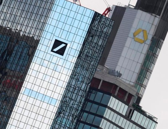 File-Picture taken March 11, 2019 shows the head offices of Deutsche Bank, left, and Commerzbank, right. (Arne Dedert/dpa via AP)