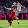 Munich's Kingsley Coman, left, and Mainz's Aaron Martin challenge for the ball during a German Bundesliga soccer match between Bayern Munich and FSV Mainz 05 in Munich, Germany, Saturday, Aug.31, 2019. (Sven Hoppe/dpa via AP)