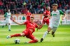 Munich's Benjamin Pavard, left, and Augsburg's Florian Niederlechner challenge for the ball during a German Bundesliga soccer match between FC Augsburg and Bayern Munich in Augsburg, Germany, Saturday, Oct.19, 2019. (Matthias Balk/dpa via AP)