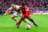 Stuttgart's Andreas Beck, left, and Munich's Kingsley Coman challenge for the ball during a German Bundsliga soccer match between Bayern Munich and VfB Stuttgart in Munich, Germany, Sunday, Jan.27, 2019. (Matthias Balk/dpa via AP)