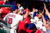 Philadelphia Phillies' J.T. Realmuto (10) celebrates a home run off Cincinnati Reds starting pitcher Tanner Roark with Bryce Harper during the fourth inning of a baseball game, Saturday, June 8, 2019, in Philadelphia. (AP Photo/Matt Rourke)