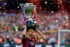 FILE - In this May 23, 2015 file photo, FC Barcelona's Xavi Hernandez holds up the trophy after winning the Spanish League title at the Camp Nou stadium in Barcelona, Spain. Midfielder Xavi Hernandez will retire from soccer this season at age 39, the former Spain and Barcelona great says. Xavi quit international football in 2014 and left Barcelona one year later after 17 seasons. He has since played for Al-Sadd in Qatar while preparing for a future as a manager. (AP Photo/Manu Fernandez, File)