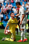Villarreal's Quintama, left, holds the ball while talking to Real Madrid's Lucas Vazquez during a Spanish La Liga soccer match between Real Madrid and Villarreal at the Santiago Bernabeu stadium in Madrid, Spain, Sunday, May 5, 2019. (AP Photo/Paul White)