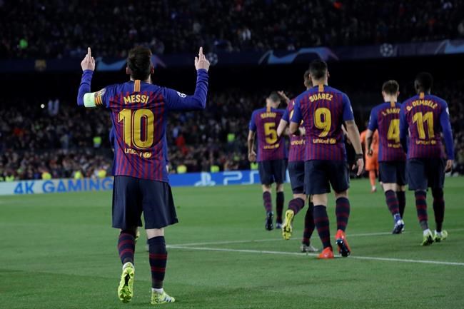 Barcelona's Lionel Messi, left, celebrates after scoring his side's third goal during the Champions League round of 16, 2nd leg, soccer match between FC Barcelona and Olympique Lyon at the Camp Nou stadium in Barcelona, Spain, Wednesday, March 13, 2019. (AP Photo/Emilio Morenatti)