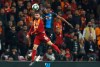 Galatasaray's Omer Bayram, left, jumps for the ball with Brugge's Amadou Sagna during the Champions League group A soccer match between Galatasaray and Club Brugge in Istanbul, Tuesday, Nov. 26, 2019. (AP Photo/Lefteris Pitarakis)