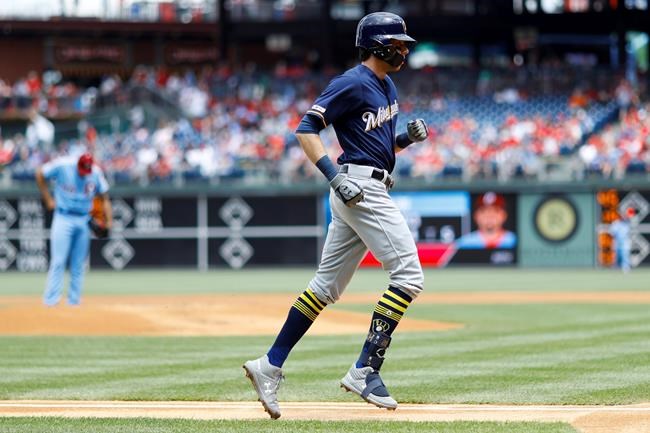 Milwaukee Brewers' Christian Yelich, right, rounds the bases after hitting a home run off Philadelphia Phillies starting pitcher Zach Eflin, left, during the first inning of a baseball game, Thursday, May 16, 2019, in Philadelphia. (AP Photo/Matt Slocum)