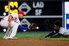 Detroit Tigers' Niko Goodrum, right, is caught stealing second by Cesar Hernandez during the sixth inning of a baseball game, Wednesday, May 1, 2019, in Philadelphia. (AP Photo/Matt Rourke)