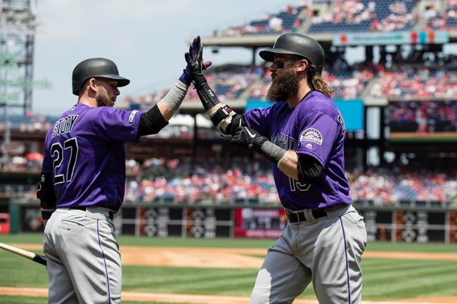 Colorado Rockies' Charlie Blackmon, right, celebrates his home run off of Philadelphia Phillies starting pitcher Jerad Eickhoff with Trevor Story during the first inning of a baseball game Sunday, May 19, 2019, in Philadelphia. (AP Photo/Matt Rourke)