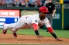 Philadelphia Phillies' Jean Segura dives into third base during the second inning of the team's baseball game against the San Diego Padres on Friday, Aug. 16, 2019, in Philadelphia. (AP Photo/Matt Rourke)