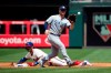 Philadelphia Phillies' Bryce Harper, bottom, advances to second base on a wild pitch ahead of the throw to San Diego Padres' Ty France during the second inning of a baseball game Sunday, Aug. 18, 2019, in Philadelphia. (AP Photo/Matt Rourke)