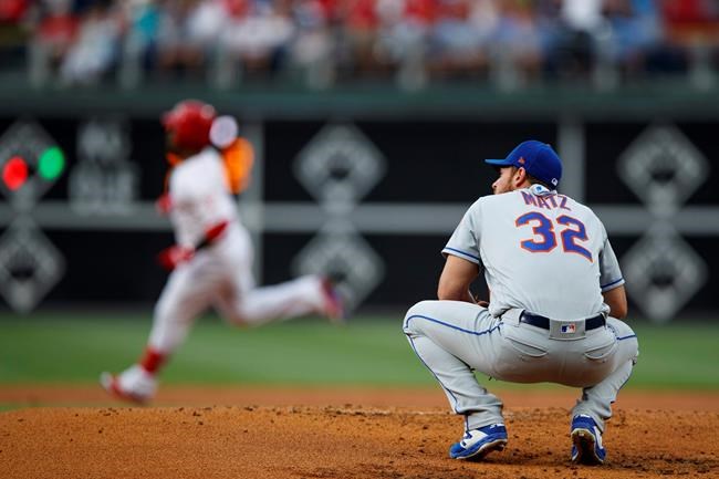 New York Mets starting pitcher Steven Matz, right, reacts after giving up a home run to Philadelphia Phillies' Jean Segura, back left, during the first inning of a baseball game, Monday, June 24, 2019, in Philadelphia. (AP Photo/Matt Slocum)