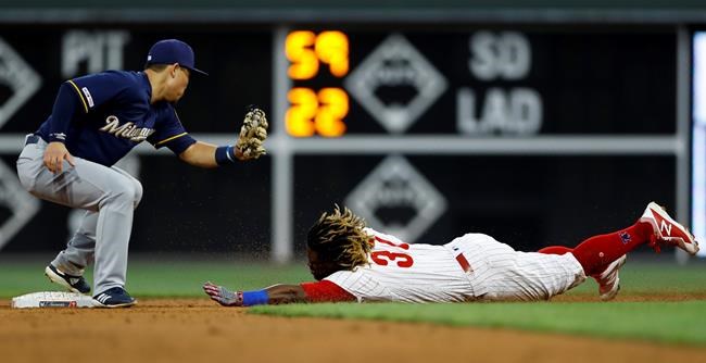 Philadelphia Phillies' Odubel Herrera, right, steals second base past Milwaukee Brewers second baseman Keston Hiura during the second inning of a baseball game, Tuesday, May 14, 2019, in Philadelphia. (AP Photo/Matt Slocum)