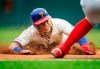 Philadelphia Phillies' Cesar Hernandez (16) steals third base as Washington Nationals' Wilmer Difo, obscured at right, waits for the ball during the fourth inning of a baseball game, Sunday, May 5, 2019, in Philadelphia. (AP Photo/Laurence Kesterson)