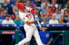 Philadelphia Phillies' Scott Kingery hits an RBI-sacrifice fly off Chicago Cubs starting pitcher Jose Quintana during the third inning of a baseball game, Tuesday, Aug. 13, 2019, in Philadelphia. (AP Photo/Matt Slocum)