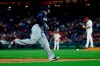 Milwaukee Brewers' Mike Moustakas, left, rounds the bases after hitting a home run off Philadelphia Phillies starting pitcher Aaron Nola, right, during the third inning of a baseball game, Monday, May 13, 2019, in Philadelphia. (AP Photo/Matt Slocum)