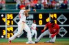 Philadelphia Phillies second baseman Cesar Hernandez, left, throws to first base after forcing out Washington Nationals' Brian Dozier at second on a fielder's choice hit by Victor Robles during the fourth inning of a baseball game, Saturday, July 13, 2019, in Philadelphia. Robles was safe at first on the play. (AP Photo/Matt Slocum)