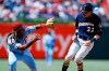 Milwaukee Brewers' Christian Yelich, right, is hit by a throw near Philadelphia Phillies third baseman Maikel Franco after Yelich advanced to third on an overthrow after stealing second during the sixth inning of a baseball game, Thursday, May 16, 2019, in Philadelphia. (AP Photo/Matt Slocum)