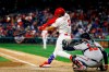 Philadelphia Phillies' Bryce Harper, left, hits a homerun off Atlanta Braves relief pitcher Shane Carle during the seventh inning of a baseball game, Sunday, March 31, 2019, in Philadelphia. At right is catcher Brian McCann. (AP Photo/Matt Slocum)