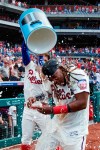 Philadelphia Phillies' Maikel Franco, right, is doused by Bryce Harper after Franco hit the game-winning home run off Washington Nationals relief pitcher Matt Grace during the ninth inning of a baseball game, Sunday, July 14, 2019, in Philadelphia. Philadelphia won 4-3. (AP Photo/Matt Slocum)