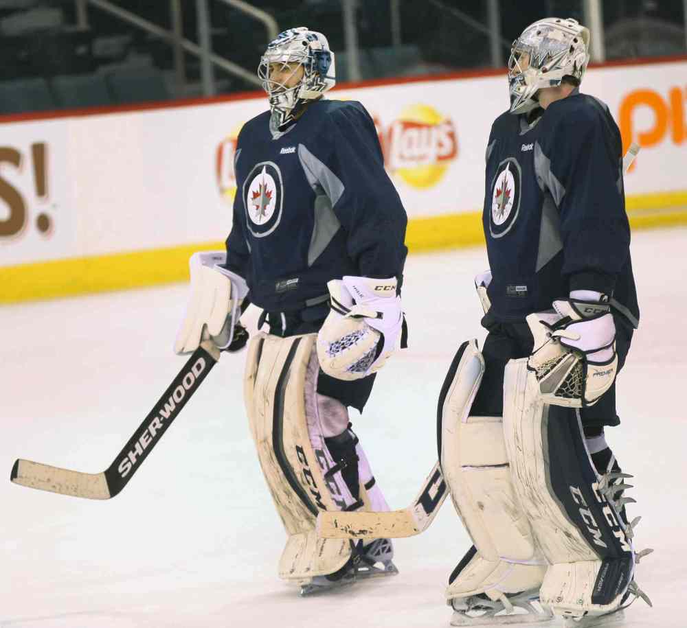JOE BRYKSA / WINNIPEG FREE PRESS
Winnipeg Jets' Ondrej Pavelec, left, chats with Connor Hellebuyck during practice at ice today at the MTS Centre.