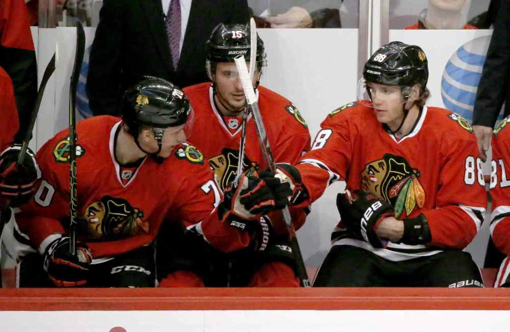 CP
Chicago Blackhawks left wing Dennis Rasmussen, left, reaches over and congratulates Patrick Kane on Kane's 600th career point, on an empty net goal, during the third period of an NHL hockey game against the Nashville Predators Tuesday, Dec. 8, 2015, in Chicago. The Blackhawks won 4-1. (AP Photo/Charles Rex Arbogast)