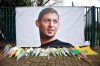 Flowers and tributes are placed near a giant picture of Argentine soccer player Emiliano Sala outside the FC Nantes training camp, in Nantes, western France, Thursday, Jan. 24, 2019, after a plane with Sala on board went missing over the English Channel on Monday night. Sobbing after the active search for her brother was halted, the sister of Argentine soccer player Emiliano Sala urged authorities Thursday not to give up trying to find the remains of his plane that disappeared from radar over the English Channel. (AP Photo)