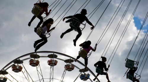 DAVID LIPNOWSKI / WINNIPEG FREE PRESS FILES
People enjoy the rides of Red River Ex Saturday evening at Red River Exhibition Park.