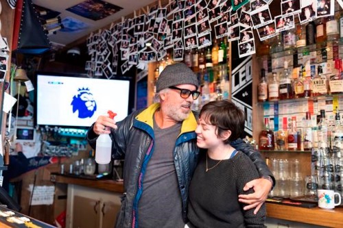Jeffrey Wimmer, left, a long-time patron jumps at the chance to be photographed with bartender Miranda Holt at Leopold's Tavern in Regina, Saskatchewan on Thursday January 3, 2019. Wimmer has been coming to the bar since it was founded in 2013. THE CANADIAN PRESS/Michael Bell